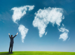 businessman with world map shaped clouds